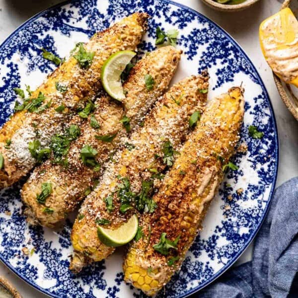 Air fryer elote on a plate from the top view.