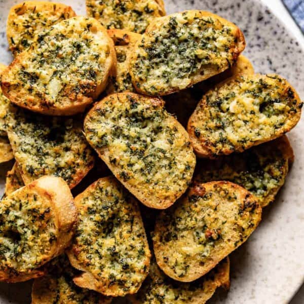 Garlic toast cooked in air fryer placed on a plate from the top view.