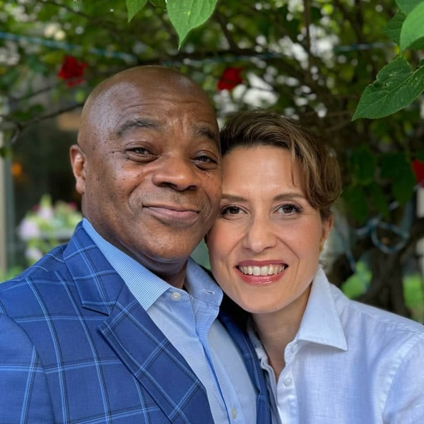 Aysegul and her husband from the front view under a tree.