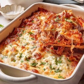 Cheesy baked ziti with meat sauce in a casserole dish, one of many fun dinner ideas for couples.