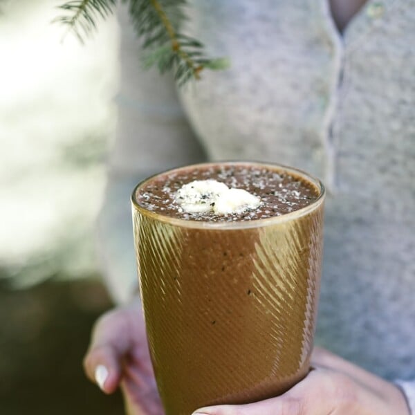 A person holding a banana split smoothie