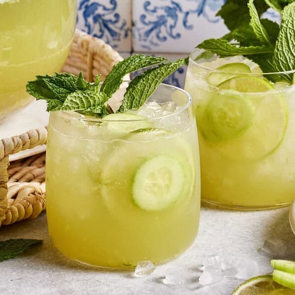 CAVA's Cucumber mint lime drink in a glass garnished with a sprig of mint.