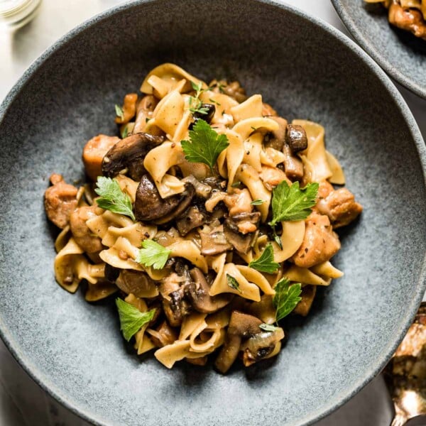 Chicken Stroganoff in a bowl garnished with parsley and thyme