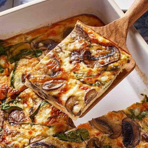 A slice of cottage cheese and egg bake on a spatula.