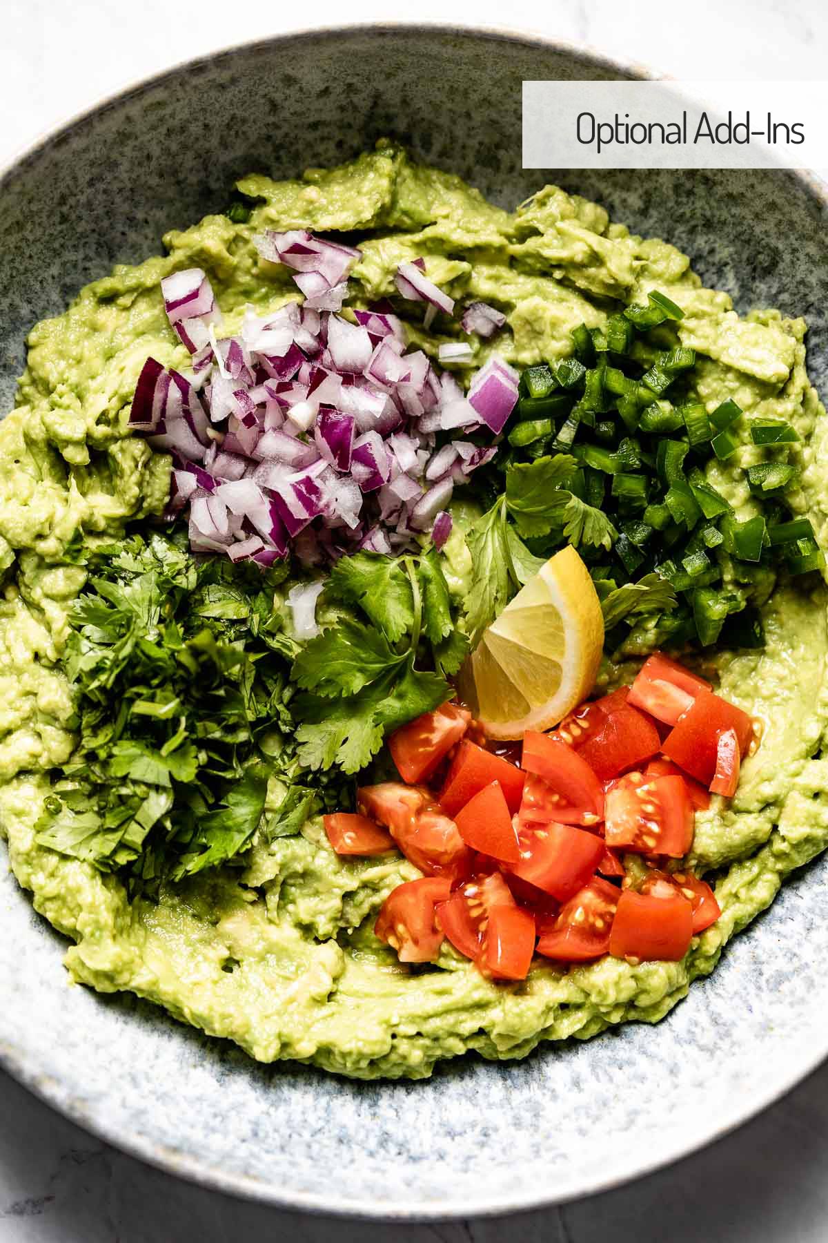 Easy guacamole with optional toppings like onion, cilantro, tomatoes and jalapenos