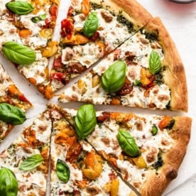 Sliced homemade Caprese pizza, a fun date night recipe to make together.