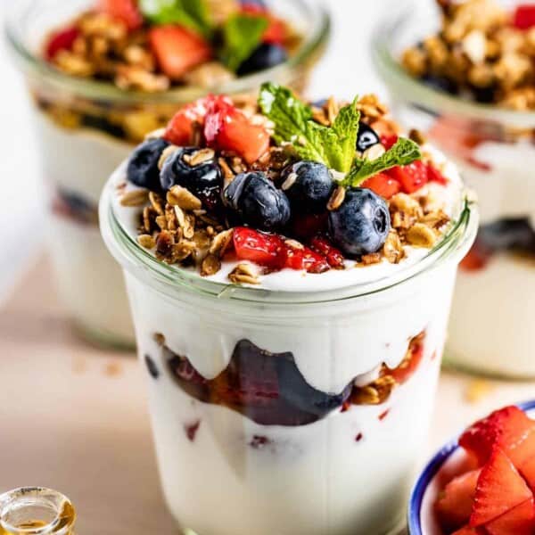 Greek Yogurt Parfait with fruit and granola layered in a jar