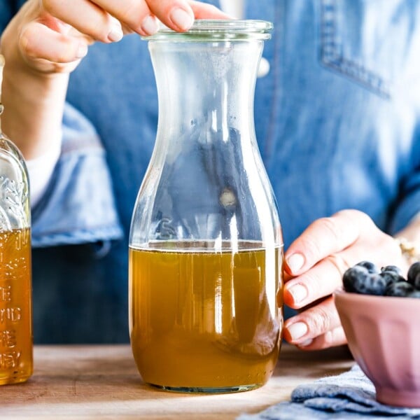 Honey simple syrup in a glass held by a person