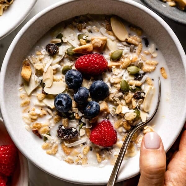 Muesli with milk in a bowl with a spoon from the top view.