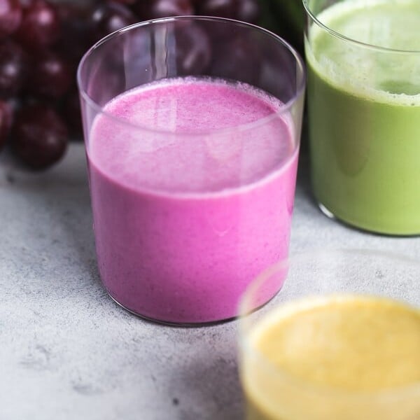 colorful beet smoothies in glasses from the front view