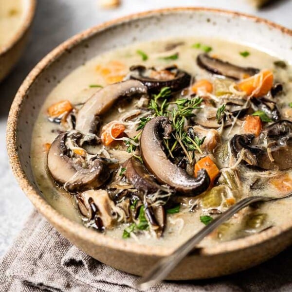 Instant Pot Chicken Wild rice soup placed in a bowl garnished with fresh thyme and photographed from the front view