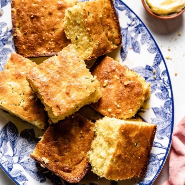 Jalapeno Cheddar Cornbread sliced and placed on a serving plate from top view.