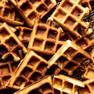 Homemade waffles on a wire rack from the top view.