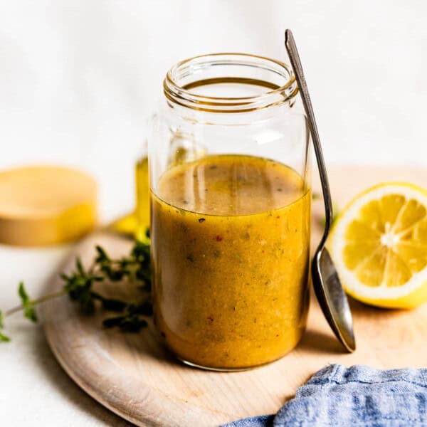 Red wine vinaigrette in a jar with a spoon on the side.