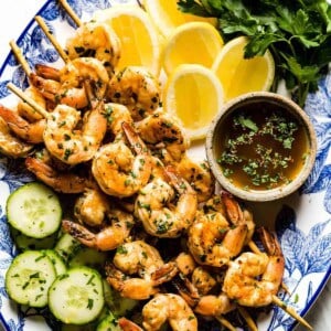 Shrimp Skewers with lemons and cucumber on the side