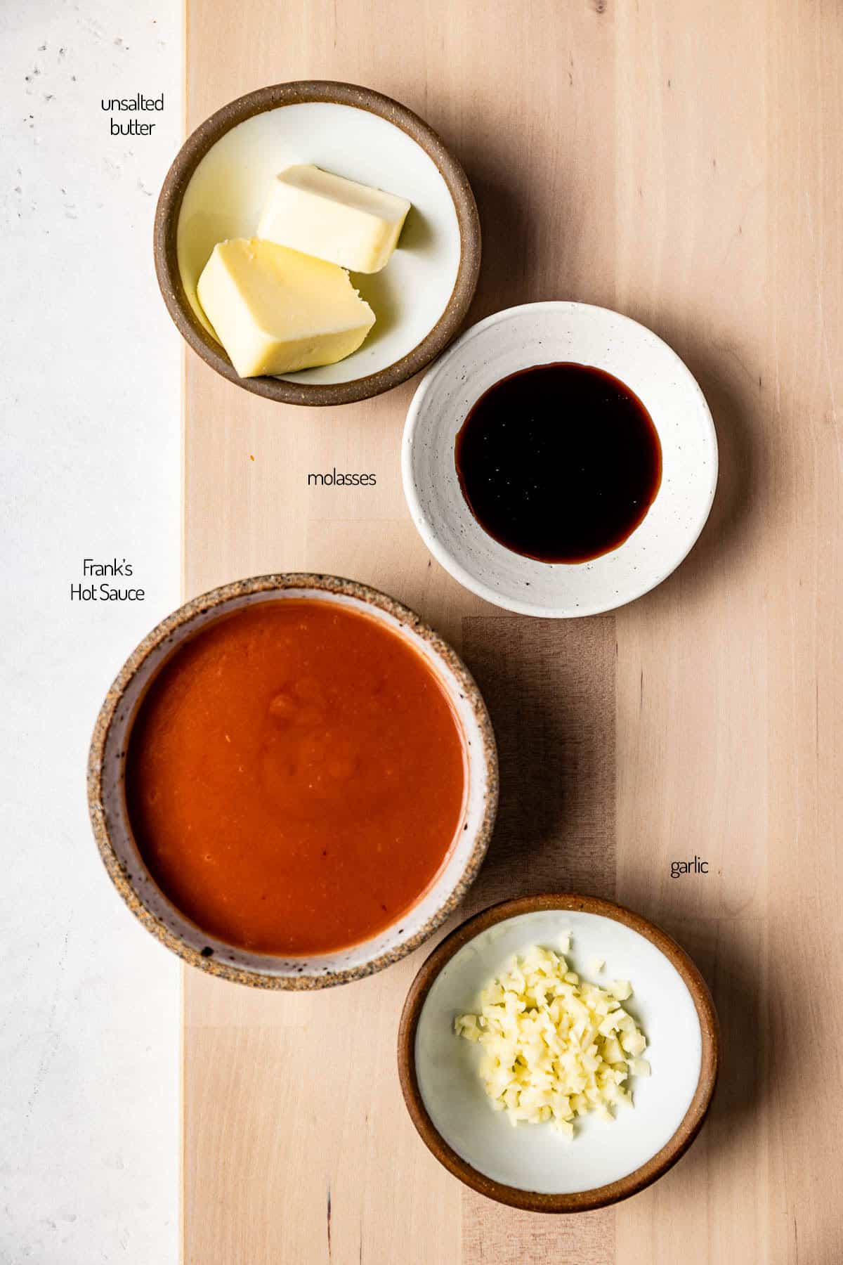 Buffalo wing sauce ingredients in small portions from the top view.