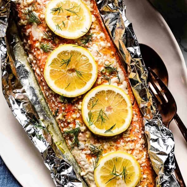 Sockeye Salmon in foil garnished with lemon slices.