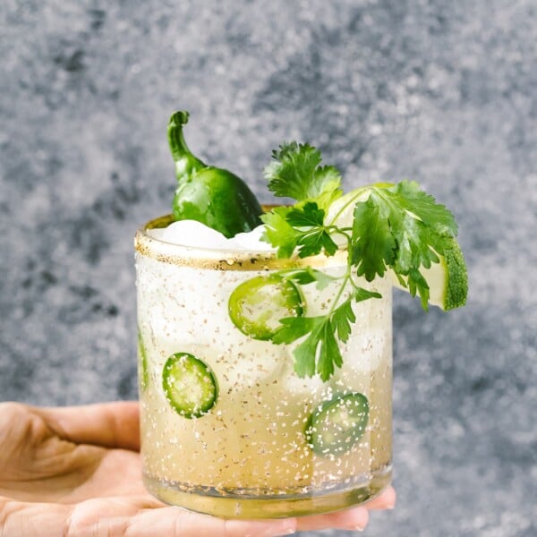 This Cilantro-infused Spicy Jalapeno Margaritas is the perfect balance between sweet, sour, and spicy all in one cocktail. Whether you make a serving for yourself or a big pitcher for a crowd, it will help you kick the cocktail hour up a few notches with very little effort.