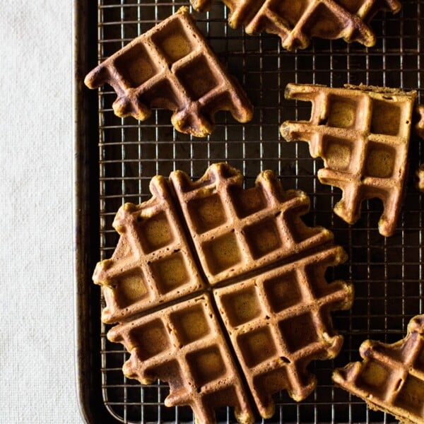 Spicy Pumpkin Waffles with Coconut Whipped Cream on a baking rack