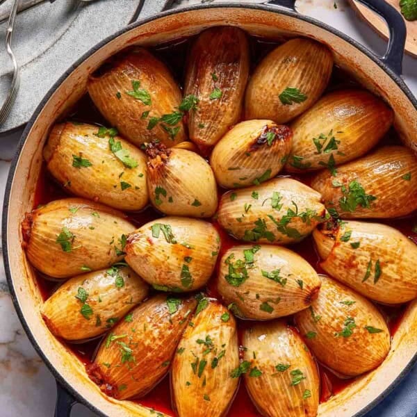 Stuffed onions in a skillet from the top view.