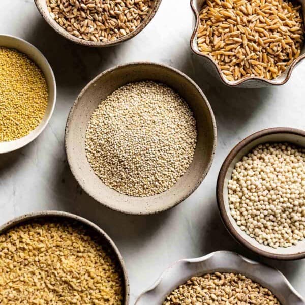 Substitution for bulgur (farro, quinoa, millet, and cracked wheat) in small bowls from the top view.