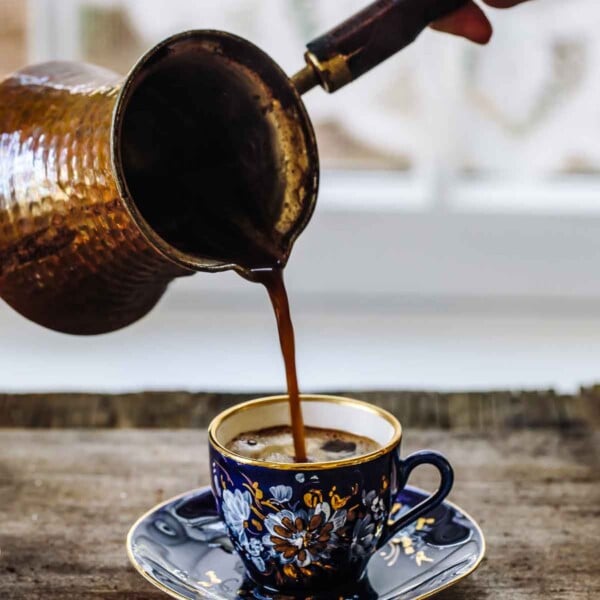 A cup of freshly brewed Turkish coffee photographed from the front view