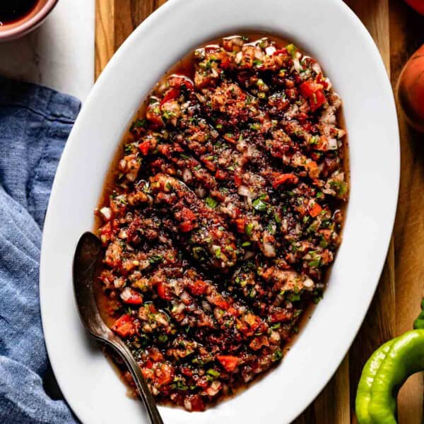 Turkish ezme on a plate with a spoon on the side.