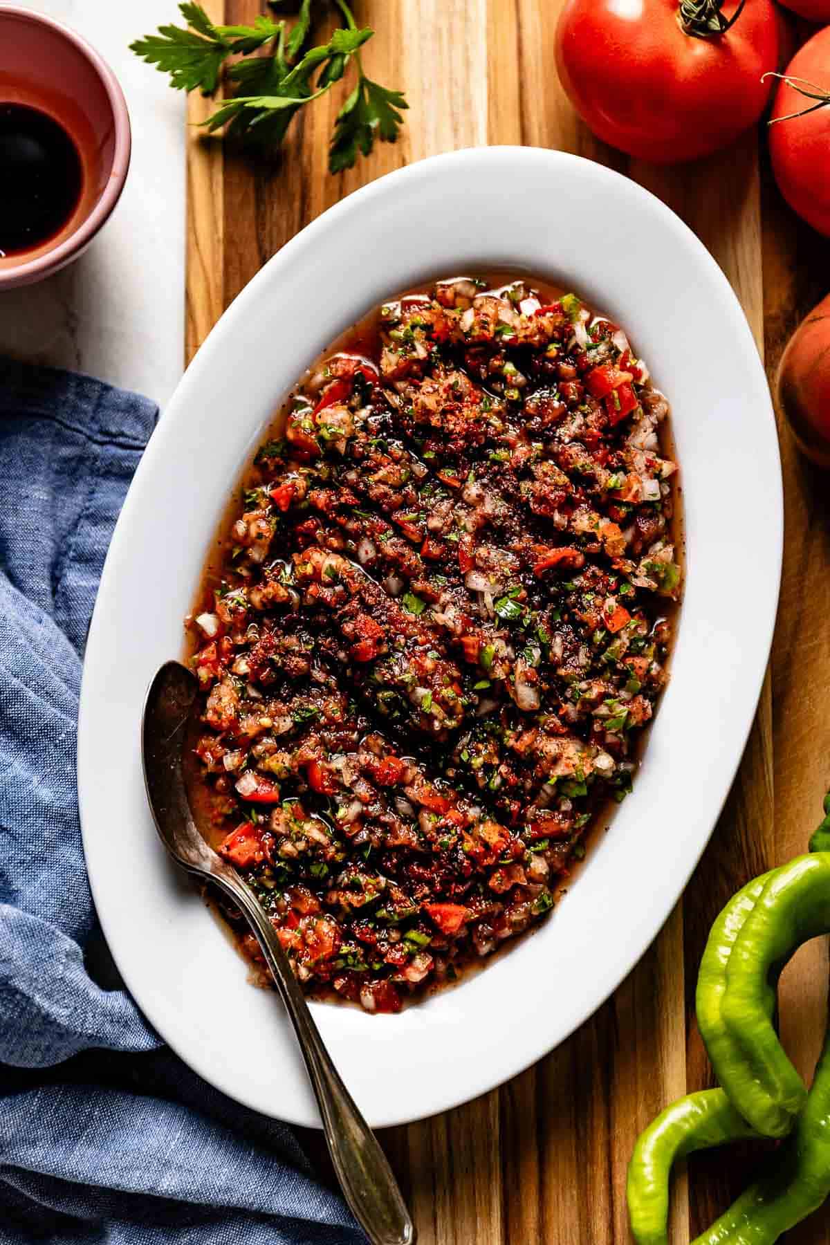 Turkish ezme on a plate with a spoon on the side.
