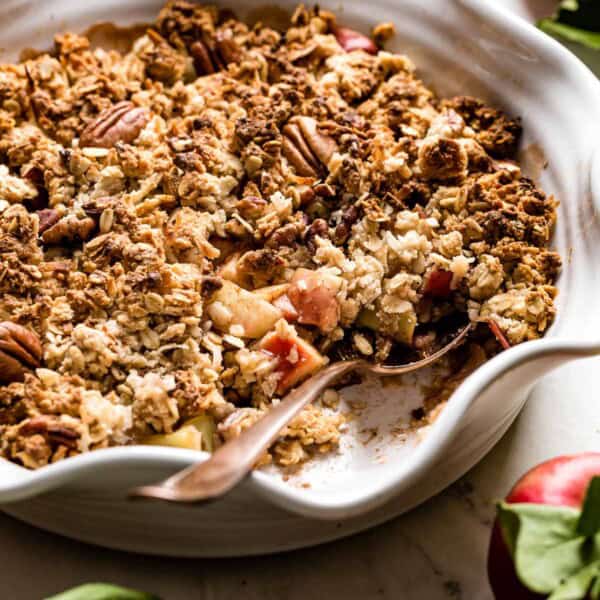 Vegan apple crisp with a spoon in the dish.