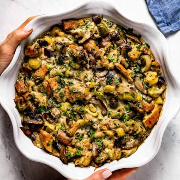 Wild mushroom stuffing right out of the oven being placed on a white counter
