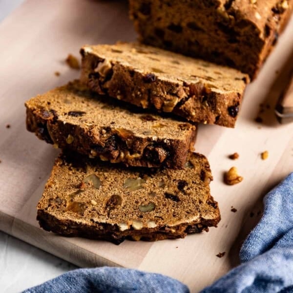 Yogurt molasses bread sliced on a cutting board.